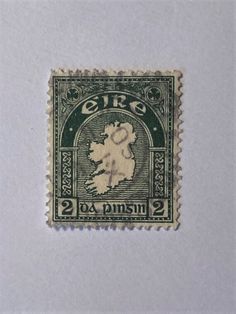 an old postage stamp with the image of a woman in green and white on it