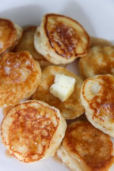 pancakes with butter and syrup on a white plate