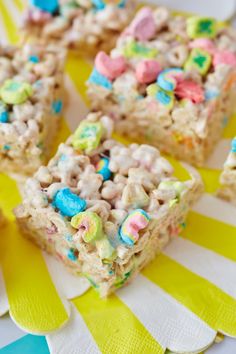 some rice krispy treats are on a yellow and white plate