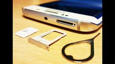 a cell phone sitting on top of a wooden table next to a pair of scissors