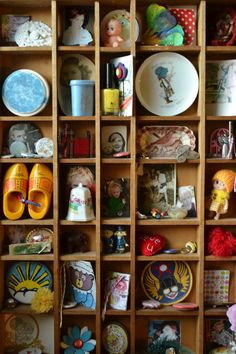 a wooden shelf filled with lots of figurines