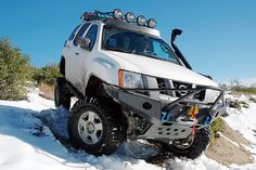 an off road vehicle driving through the snow