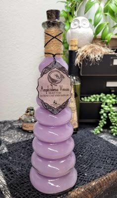 a bottle of lavender wine sitting on top of a table