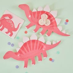 two pink paper dinosaurs with sprinkles and confetti