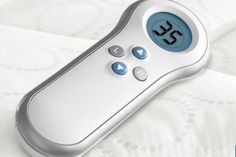 a close up of a remote control on a bed with the word sleep written in it