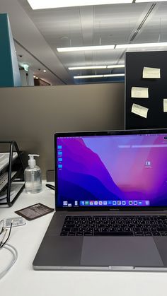 an open laptop computer sitting on top of a white desk