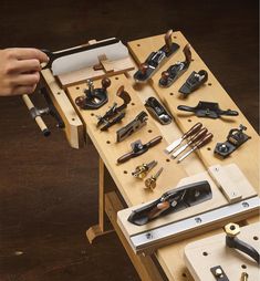 a person is working with tools on a workbench