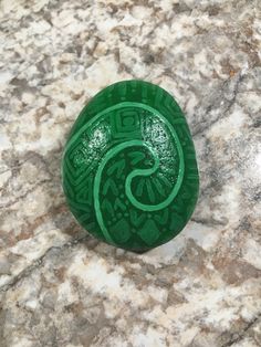 a green object sitting on top of a marble counter