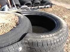 two tires sitting next to each other on top of dry grass and dirt covered ground