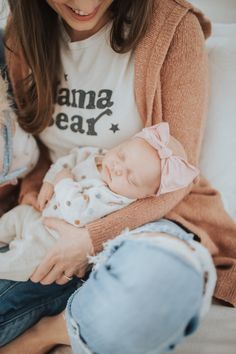 a woman holding a baby in her arms