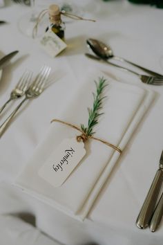 a place setting with silverware and napkins