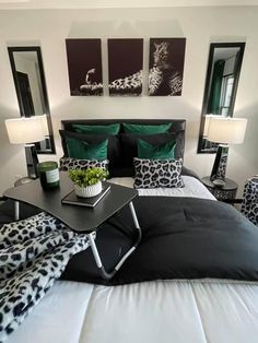 a black and white bedroom with green accents