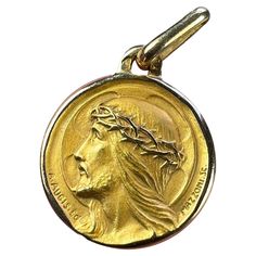 A French 18 karat (18K) yellow gold charm pendant designed as a round medal depicting the profile of Jesus Christ wearing the Crown of Thorns, in front of a halo shaped like a cross. Signed A.Augis and Mazzoni. Stamped with the eagle’s head for 18 karat gold and French manufacture, along with the maker's mark for Augis. Dimensions: 1.7 x 1.4 x 0.15 cm (not including jump ring) Weight: 2.25 grams (Chain not included) Christ Crown, The Crown Of Thorns, Crown Of Thorns, Jesus Christus, Gold Medal, Pendant Design, Gold Charm, Jump Rings, Charm Pendant