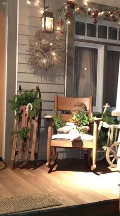 a rocking chair sitting on top of a wooden floor next to a window covered in christmas lights