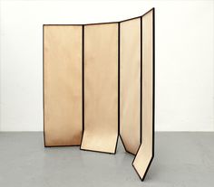 four panels are arranged in the shape of a curved piece of wood, with one section closed