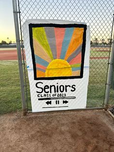 a sign on the side of a fence that says seniors class of 2013 at sunset