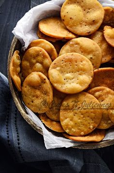 a bowl filled with crackers sitting on top of a table