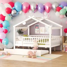 a baby's room decorated in pastel colors and balloons