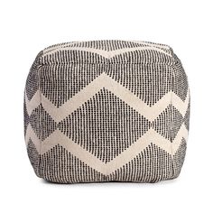 a black and white poufce with geometric pattern on the top, sitting on a white background