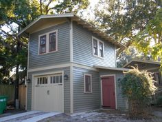 a two story house with a red door