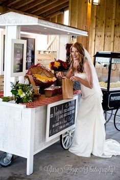 a woman standing in front of a food cart