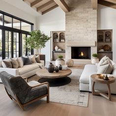 a living room filled with furniture and a fire place in the middle of a room