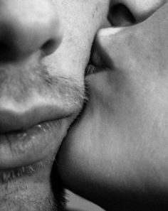 a man and woman kissing each other with their noses close to one another's face