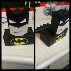 two pictures of batman boxes sitting on top of a white table with black and yellow decorations