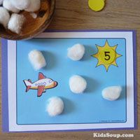 a wooden table topped with marshmallows next to a card