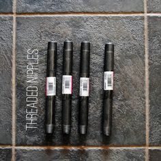 four different types of pens sitting on top of a tile floor