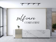 there is a marble counter in front of a wall that says self care comps first