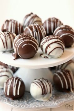 chocolate covered truffles on a white cake plate