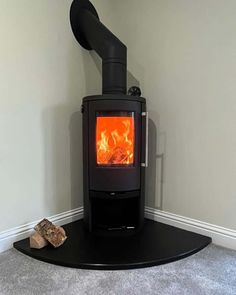 a black stove sitting in the corner of a room