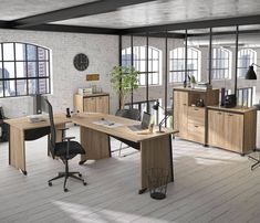 an office area with desks, chairs and shelves on the floor in front of large windows