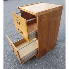 a wooden cabinet with two drawers on the bottom and one drawer open to show what's inside