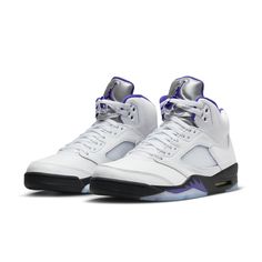 The Air Jordan 5 Retro Concord brings a classic color scheme with a modern twist. It features a sleek white leather upper, TPU netted underlays, and a reflective tongue all contrasted by accents of Concord found on the Jumpman logos, midsole shark teeth, and sockliner. Black is seen on the midsole with an Air cushioning heel unit and semi-translucent icy outsole finishing the design. A must-have for any sneaker fan's collection, this pair contributes throwback style to any look. Classic White Basketball Shoes With Contrast Sole, Classic White Leather Basketball Shoes, Modern White Leather Basketball Shoes, Classic Leather Sneakers With Padded Tongue, Classic White Basketball Shoes, Classic White Sneakers With Padded Tongue, Classic Basketball Shoes With Abzorb Midsole, Jordan 5 Concord, Jordan 5s