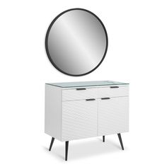 a white dresser with a round mirror above it and black legs on the sideboard