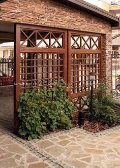 a brick building with an iron gate and planters on the sidewalk in front of it