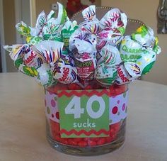 a glass vase filled with candies on top of a table