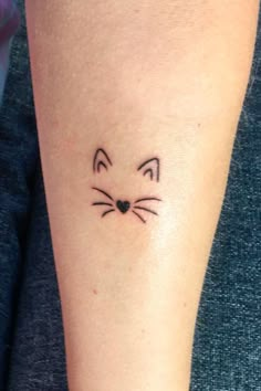 a cat's face is shown on the left side of the arm, which has a black outline