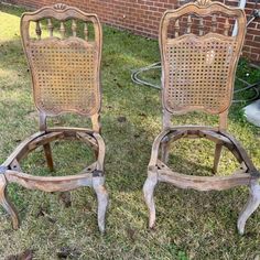 two old wooden chairs sitting in the grass