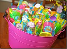 a pink bucket filled with lots of toys