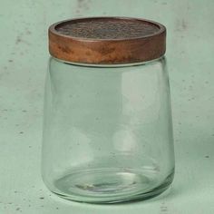 an empty glass jar with a wooden lid