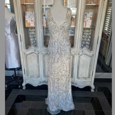 a dress on display in front of a white cabinet