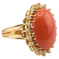 This is an exceptional, gorgeous Italian momo coral gold ring. It is surrounded with many diamonds to give it even more of a gorgeous sparkle. The color of the coral is natural and has not been dyed or processed like many other corals in the market. It has a nice dark red color better than the normal salmon or white color. The coral has a nice smooth luster feeling that shines at every angle. The gold purity on the ring is 14 karat. The quality on the diamonds ranges SI clarity from GHI color di Elegant Coral Ring Jewelry, Elegant Coral Rings For Anniversary, Coral Elegant Wedding Rings, Elegant Coral Wedding Rings, Coral Jewelry Vintage, Dark Red Color, Coral Ring, Coral And Gold, Coral Jewelry