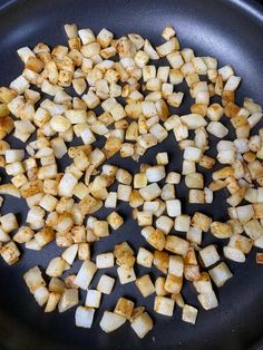 chopped potatoes are being cooked in a skillet