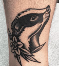 a close up of a person's leg with a tattoo design on the thigh