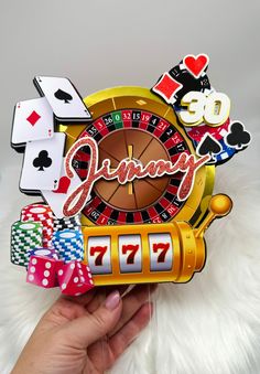 a person holding up a clock with casino cards and dice around it