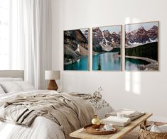 a bedroom with three pictures hanging on the wall