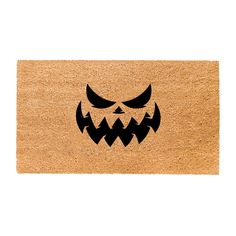 a door mat with an evil face on it